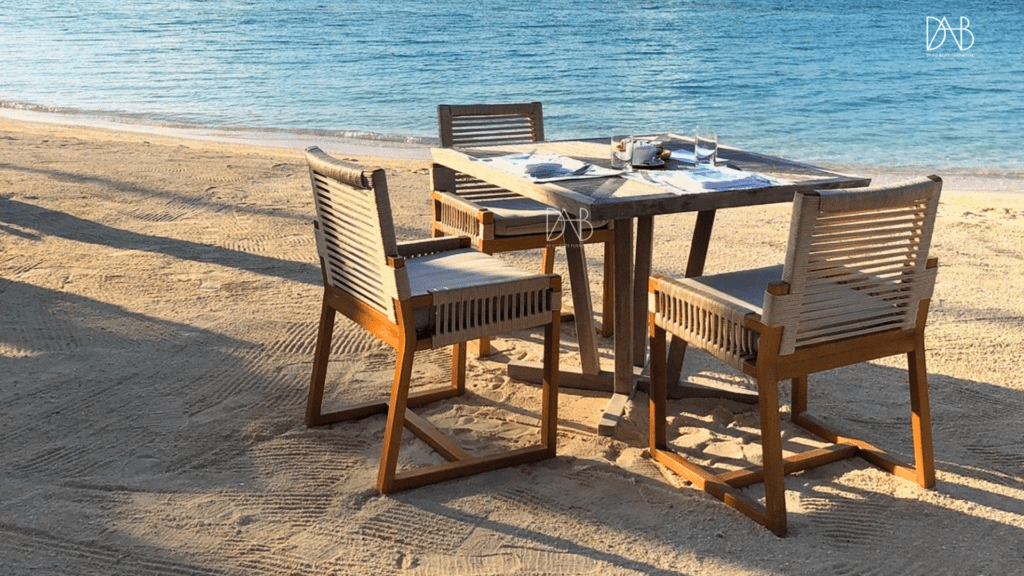 3 rope chairs and a table on the beach